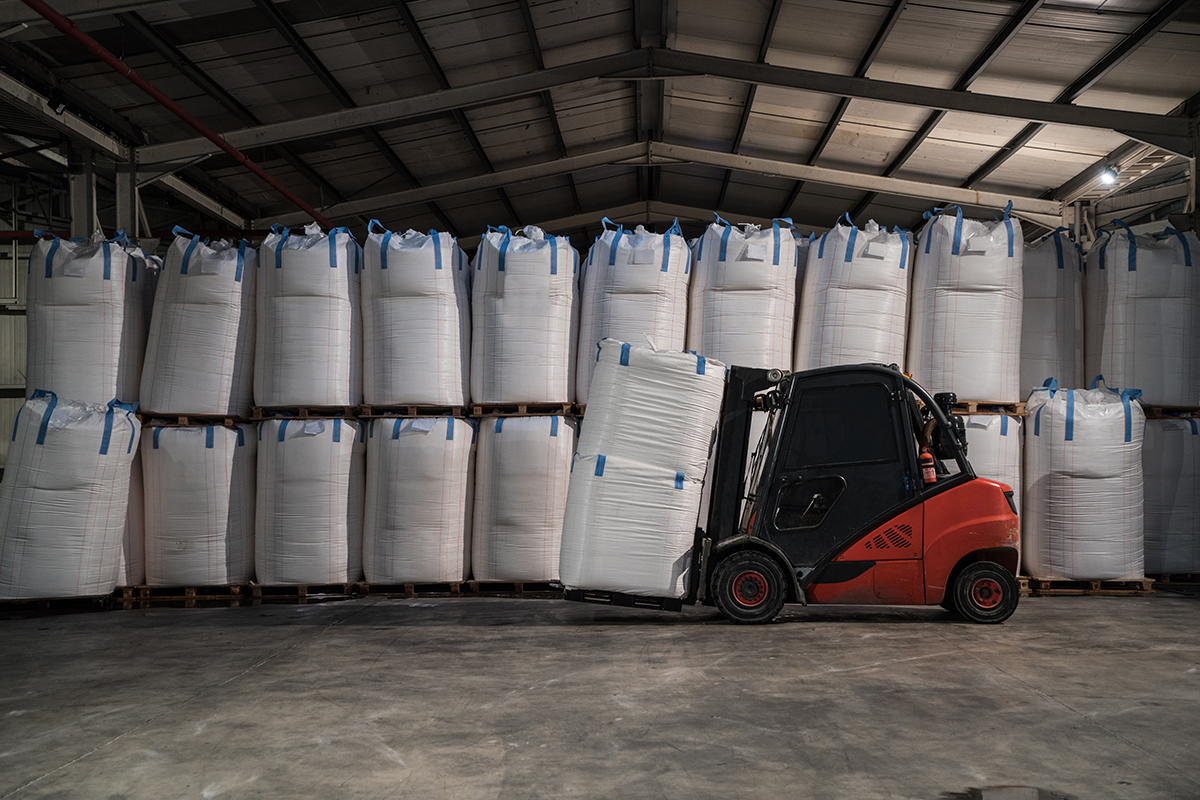 Forklift Carrying chemical sack in storage room